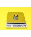 Smooth Hybrid Ceramic Ball Bearings For Motor Spindles And Industrial Gearboxes weighing 27.95 grams on a digital scale.