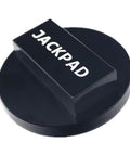 Close-up of black anodized jack pad adapter with round base and rectangular top labeled JACKPAD