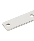 Close-up of stainless steel door hinge plate with two mounting holes