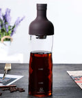 Eight Hundred Milliliter Glass Cold Brew And Iced Coffee Drip Maker With Splash Drip Proof Lid, borosilicate glass, dark coffee, kitchen setting.
