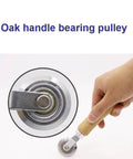 Close-up of a hand holding a Precise 0.5mm Cardboard Scoring Tool with durable metal wheel and ergonomic oak handle.