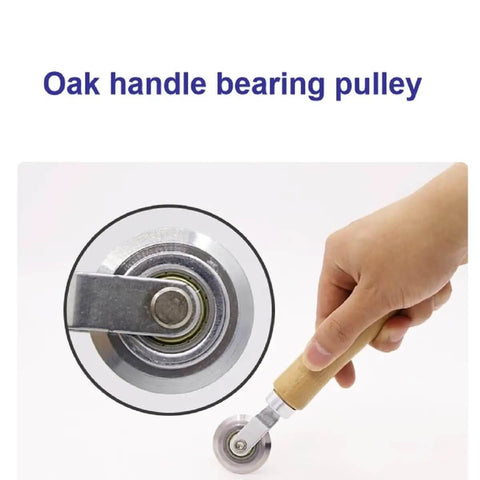 Close-up of a hand holding a Precise 0.5mm Cardboard Scoring Tool with durable metal wheel and ergonomic oak handle.