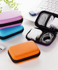 Badass Hard Storage Suitcase for Electronic Accessories, Rad Portable Organizer Bag for Power Cords, Chargers, and Headphones, Sweet Orange Stash Case with assorted colors.