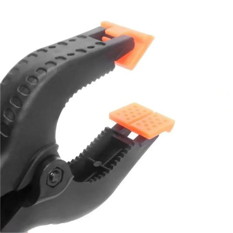 Close-up of open Heavy Duty Nylon Spring Clamp Set For DIY Woodworking, 9 Inch Clamps For Carpenter Home Workshop, with orange pads.