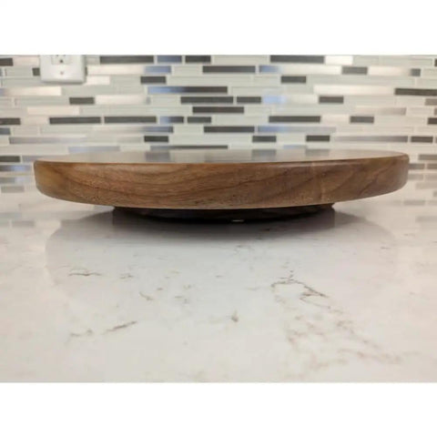 Side view of 12 Inch Walnut Lazy Susan Turntable Serving Tray with Non Slip Rotating Base on kitchen countertop