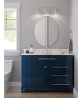 Adley Collection 3 Light Clear Glass Bath Vanity Light Polished Nickel Finish Wall Mounted Traditional Fixture over blue vanity
