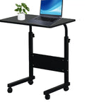 Rock Solid Adjustable Height Rolling Computer Desk With Smooth As Butter Locking Casters Portable Standing Laptop Table For Tight Quarters And Remote Work Setup In Glossy Black with laptop and plant.
