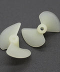 White Nylon 2 Blade RC Boat Propellers, 22mm Diameter, showing two model ship props on dark surface
