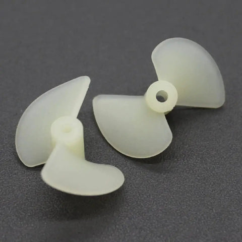White Nylon 2 Blade RC Boat Propellers, 22mm Diameter, showing two model ship props on dark surface