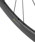 Close-up of 50mm Carbon Fiber Road Bike Wheelset Disc Brakes 700c Tubeless Ready rim, showing carbon fiber texture and spokes.