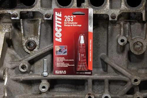 Front view: Loctite 263 red threadlocker, 6 ml tube in red box on an automotive engine block.