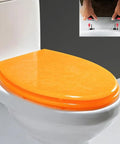 Slick Glitter Toilet Seat Soft Close Rounded Molded Resin Cover in bright orange color, showcasing quick setup features.