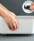 Hands attaching 16 Piece Self Adhesive Caster Wheels Mini Swivel Casters Sticky Plastic Rolling Kit to a white storage container.