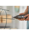 Dremel EZ Lock rotary tool with cutting wheel cutting metal wire frame; sparks.