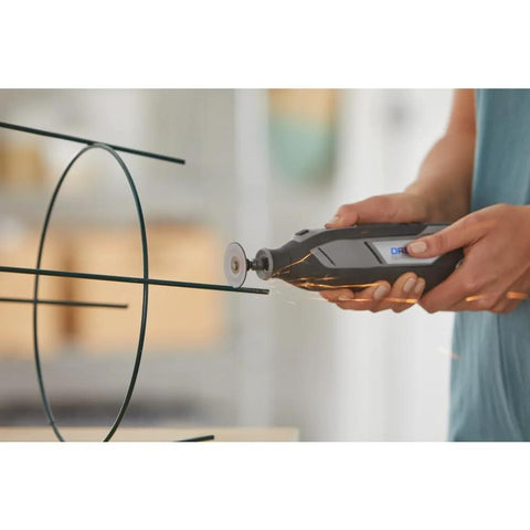 Dremel EZ Lock rotary tool with cutting wheel cutting metal wire frame; sparks.