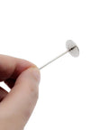Premium Upholstery Nails And Long Furniture Tacks With Slick Silver Flat Heads For Sofa Restorations and Headboard Builds, held in hand.