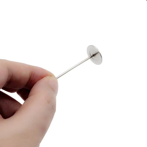 Premium Upholstery Nails And Long Furniture Tacks With Slick Silver Flat Heads For Sofa Restorations and Headboard Builds, held in hand.