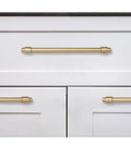 5 Pack Brushed Brass Cabinet Pulls Zinc Alloy Die Cast Modern Minimalist Hardware For Kitchen Bath And Bedroom Cabinets installed on white drawers