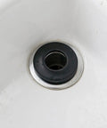 Close-up of a black rubber bathtub drain gasket in a smooth white bathtub, 10pcs Rubber Bathtub Drain Gasket Washer Seal Ring.