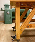 Heavy Duty Steel Caster Set For Router Tables, Workbenches, Cabinets And Tool Stands With 800 LB Capacity attached to bench leg