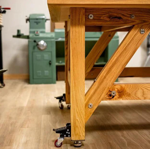Heavy Duty Steel Caster Set For Router Tables, Workbenches, Cabinets And Tool Stands With 800 LB Capacity attached to bench leg