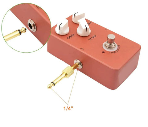 Gold Plated 1/4 Inch Guitar Pedal Connectors 6 Pack, male to male straight plugs attached to a guitar pedal for easy cable management.