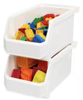 Set Of Six Crisp White Stackable Storage Bins Featuring Lockdown Grip Base And Crystal Clear Front Panels To Kick Pantry Chaos To The Curb And Tame Craft Tables with colorful building blocks.