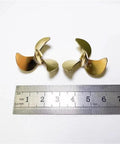 32mm Brass Right Hand Three Blade Propeller for RC Submarines with M3 Shaft Hole Scale Model Propeller next to ruler