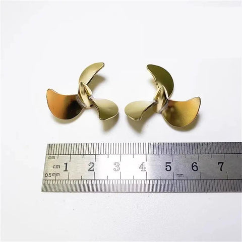 32mm Brass Left Hand 3 Blade Propeller for RC Submarines With M3 Shaft Hole beside ruler for scale reference