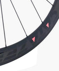 Close-up of Carbon Road Bicycle Wheelset Clincher 50mm Deep Rim Basalt Brake Surface 3K Weave With Novatec ABG Hub.