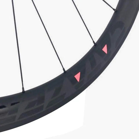 Close-up of Carbon Road Bicycle Wheelset Clincher 50mm Deep Rim Basalt Brake Surface 3K Weave With Novatec ABG Hub.