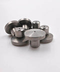 Waterjet outlet seat parts, metal discs with central holes, front view.