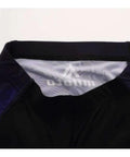 Close-up of waistband with logo on black and blue athletic shorts.