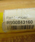 Product label showing part number R900843160 for piston rod with protective yellow mesh packaging visible.