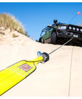 Full Size Winch Extension Strap Four Inch By Thirty Foot Polyester Webbing With Reinforced Eyelets Tough Built To Last Off Road Recovery Gear Built For Real World Use 31,360 Lbs Minimum Breaking Strength attached to off-road vehicle in desert terrain
