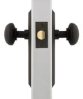Side view of New York Style Door Knob with Plate Classic Round Knob and Long Back Plate for Interior Doors in black finish.
