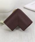 Close-up of a brown corner protector with impact absorption, part of a 12 pack NBR safety edge guards for furniture and chairs.