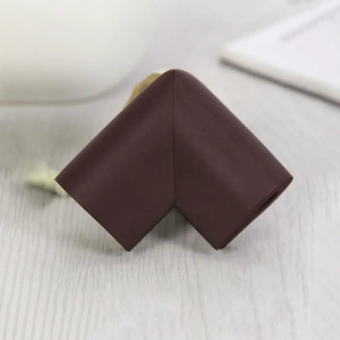 Close-up of a brown corner protector with impact absorption, part of a 12 pack NBR safety edge guards for furniture and chairs.