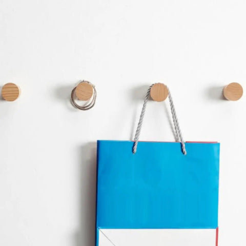 No Fuss Solid Wood Wall Hooks Holds Bags Hats And Coats Game Changer In Home Organization Multi Purpose Coat Rack And Towel Holder showing mounted hooks with a blue bag hanging.