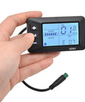 Hand holding Weatherproof 5 Pin LCD Display for Electric Bikes showing speed and assist levels, Waterproof Bike Dashboard for 22.2mm Handlebars, Easy Install GD01 Style Indicator, DIY Modification Accessory for Cyclists