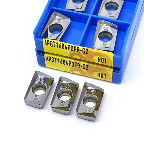 10pcs APKT/APGT carbide milling inserts in blue plastic case; front view shows square silver inserts with centered hole.
