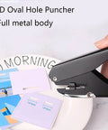 Oval Hole Puncher For Office Use 10 Sheet Capacity Adjustable Paper Depth Heavy Duty Metal Body Black Finish in use