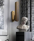 Top Shelf Copper Wall Sconces With Bright Acrylic Shades For Bedrooms And Living Rooms Sleek Glare Free Lighting mounted beside a bust.
