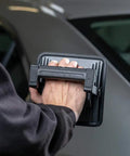 Person holding MultiMatch R 1200 Lumen LED Work Light for painting jobs, showing handheld portability and ergonomic design.