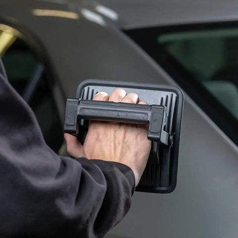 Person holding MultiMatch R 1200 Lumen LED Work Light for painting jobs, showing handheld portability and ergonomic design.