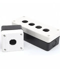 Two-piece white plastic button box with four top ports and black base; automotive electrical junction box assembly.