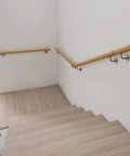 Premium Solid Oak Wall Mount Stair Handrail Featuring Heavy Duty Metal Brackets on indoor staircase with smooth finish.