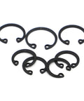 Rock Solid Black Internal Retaining Rings And C Clips M8 Through M50 Shaft Circlips arranged in various sizes, carbon steel material.