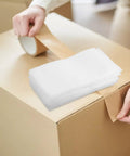 White Epe Foam Wrap Pouches 200 Pack For Packing And Shipping on cardboard box with tape, flexible cushion foam bags.