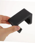 Person holding black outdoor furniture clip. Super Practical Outdoor Patio Furniture Clips Keep Your Sectional Couch Pieces Secure And Neat Prevent